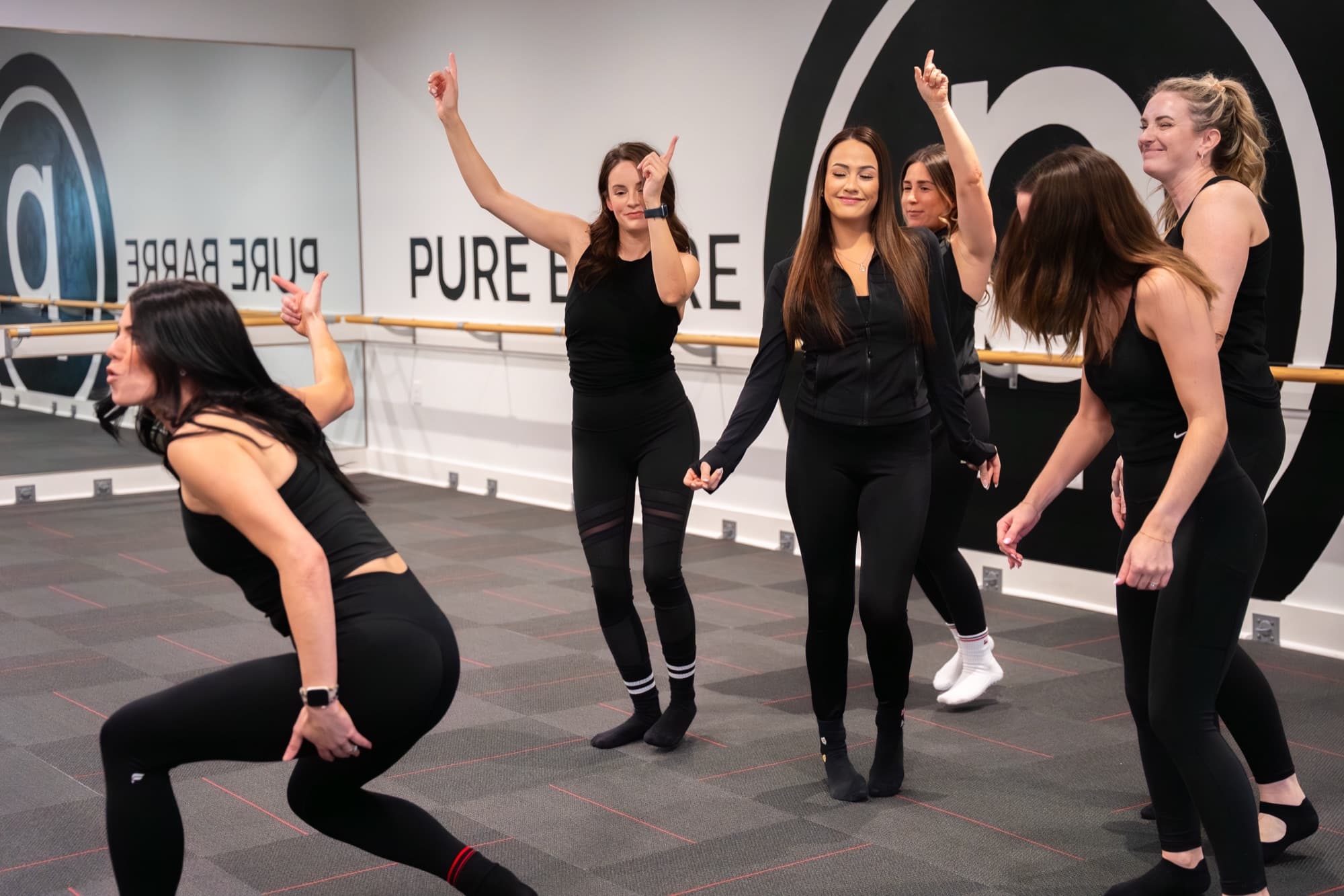 A full class lined up at the barre